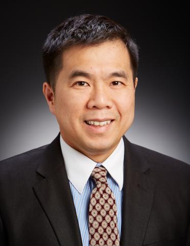 Headshot image of George Ho dressed in suit and tie
